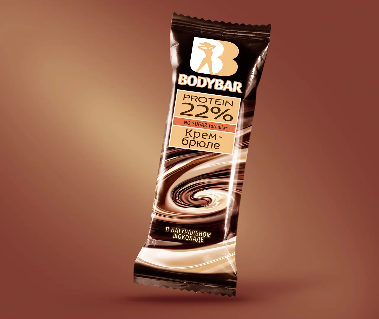 Протеиновый батончик BODYBAR в коричневой упаковке с закрученным шоколадным дизайном, с этикеткой «22% белка, без сахара, со вкусом крем-брюле», изготовлен из натурального шоколада и входит в коллекцию Soldis.