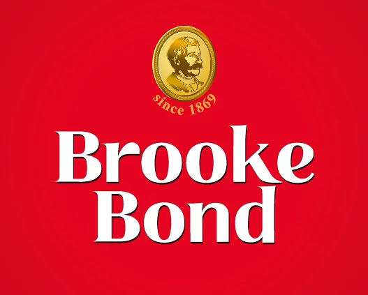 Логотип Brooke Bond на красном фоне, включающий золотую эмблему с мужским профилем и текстом «с 1869 года» над жирными белыми словами «Brooke Bond», улучшен компанией Soldis для придания ему вневременной привлекательности.