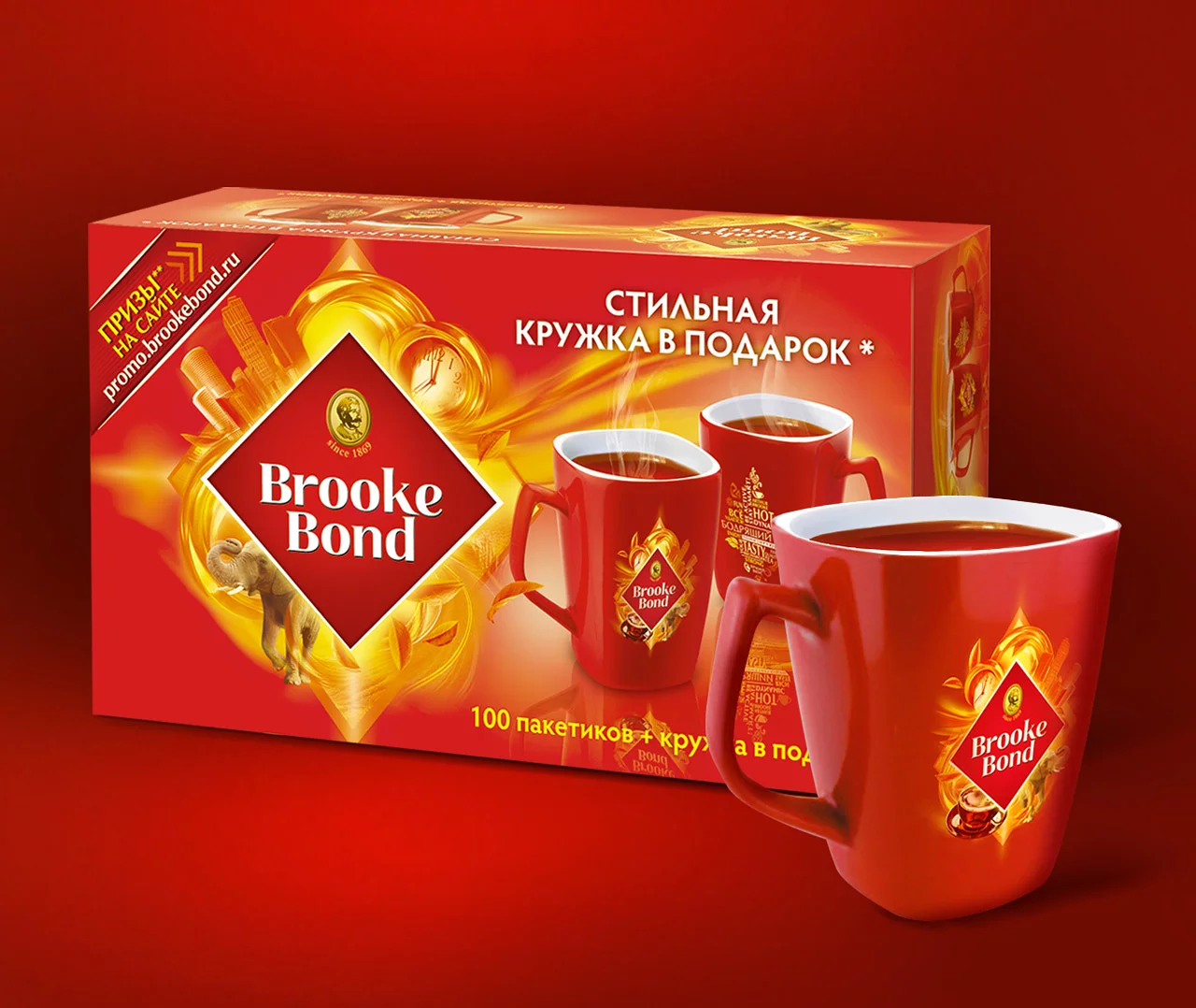 Красная коробка чая Brooke Bond с золотыми акцентами, с тремя красными кружками, наполненными чаем. Текст на русском языке, а на упаковке изображен логотип Brooke Bond, акция Soldis и стильная кружка в подарок.