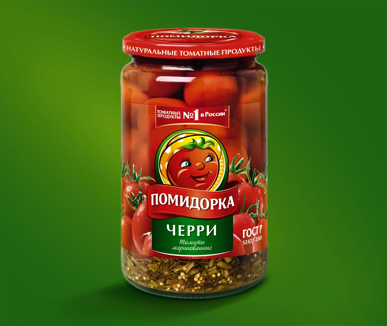 Стеклянная банка маринованных помидоров черри марки «Помидорка» с красной крышкой, на которой изображен улыбающийся мультяшный помидор и текст на русском языке на зеленом фоне. Дистрибьютор — Soldis.